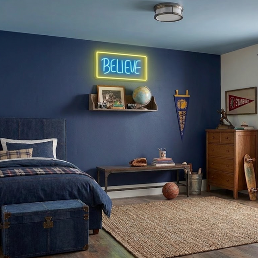 Neon 'BELIEVE' sign on a blue wall in a bedroom with furniture and decor.