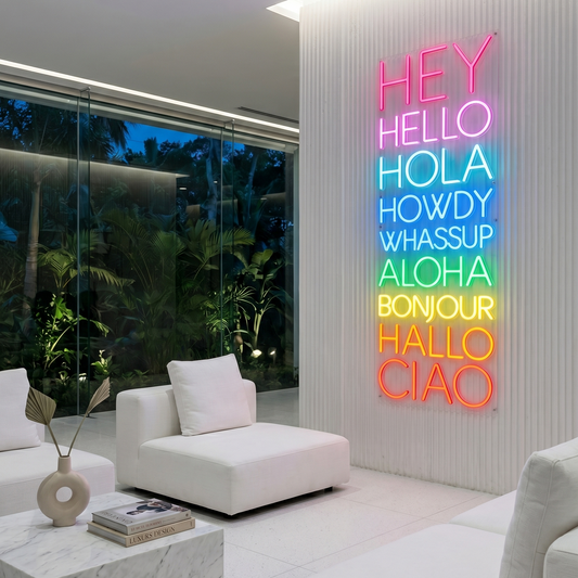 Modern living room with a colorful neon sign on a white wall.