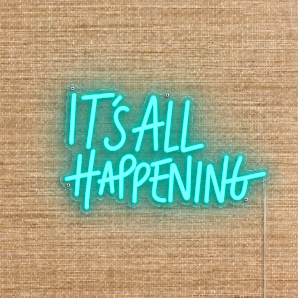 Ocean Teal It’s All Happening LED neon sign on beige woven wallpaper with clear acrylic backing and silver mounting screws.